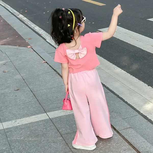ست کراپ و شلوار دخترانه وارداتی صورتی، مناسب 2 تا 8 سال، جنس 100 درصد پلی‌استر، با عروسک خرگوش برجسته و پاپیون، پرداخت درب منزل، درگاه امن بانکی و ارسال با پست پیشتاز.